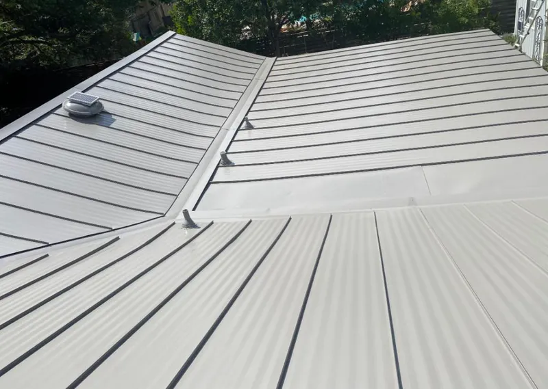Solar attic fan installed on a metal roof for Roof Ventilation in Roscoe